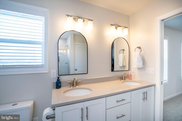 bathroom featuring vanity and a shower with door