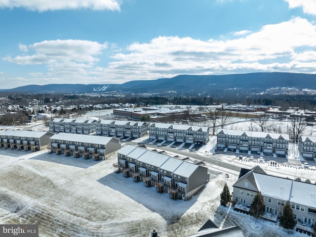 snowy aerial view featuring a mountain view