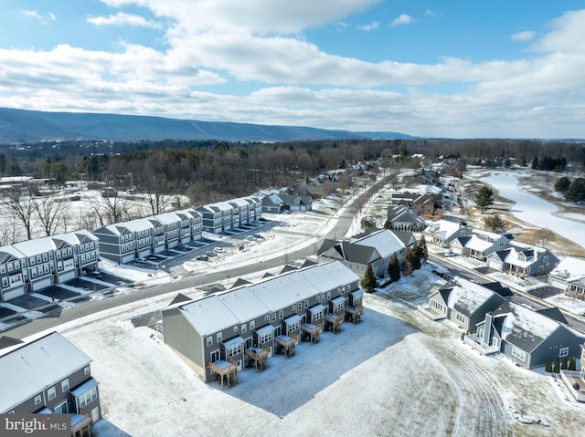 snowy aerial view featuring a mountain view