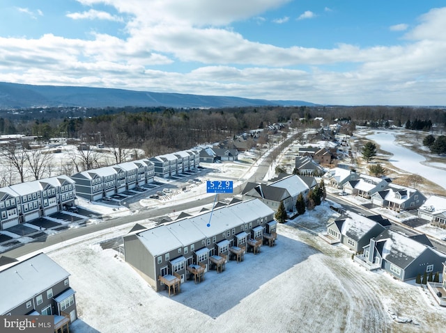 snowy aerial view with a mountain view