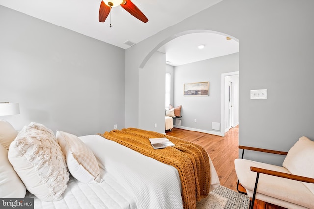 3100 E Lombard St, Baltimore, MD 21224 - bedroom with arched walkways, wood finished floors, baseboards, and a ceiling fan