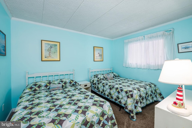 bedroom with carpet flooring, a textured ceiling, and crown molding