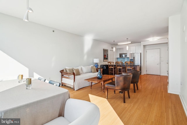 living room with light wood finished floors and baseboards