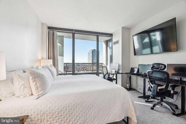 bedroom featuring access to exterior, visible vents, a wall of windows, and carpet flooring