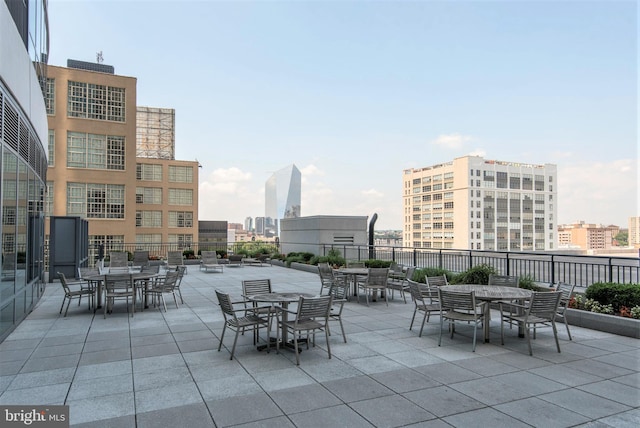 view of patio / terrace with fence and a city view