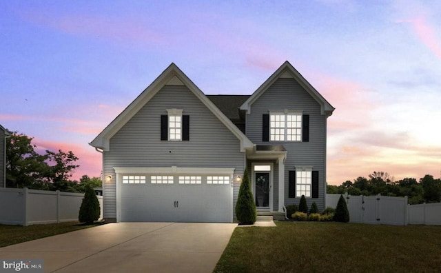 view of front of house featuring a garage and a lawn