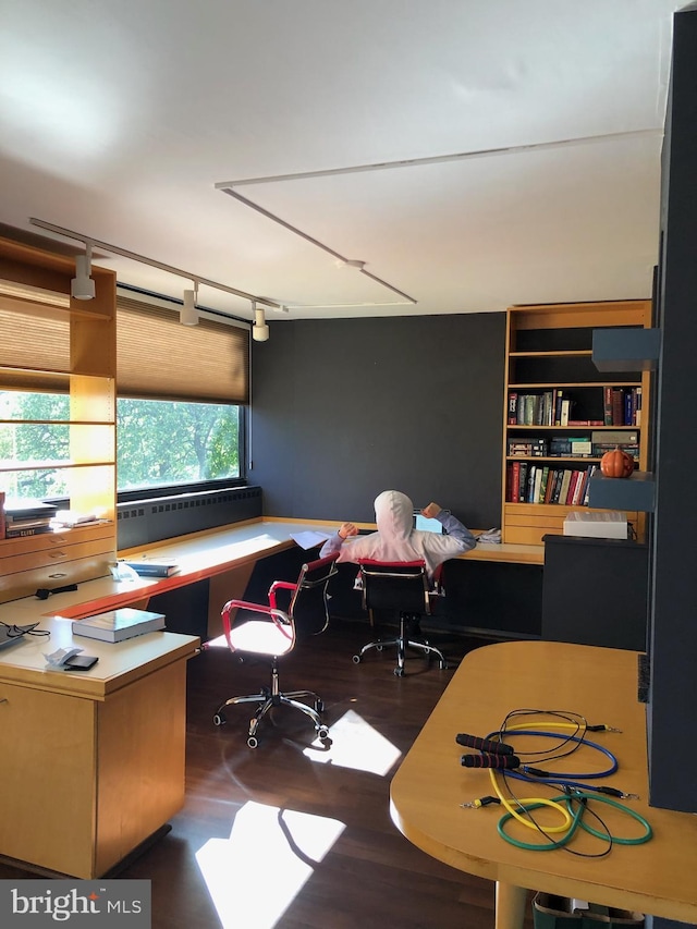 home office featuring dark hardwood / wood-style flooring and rail lighting