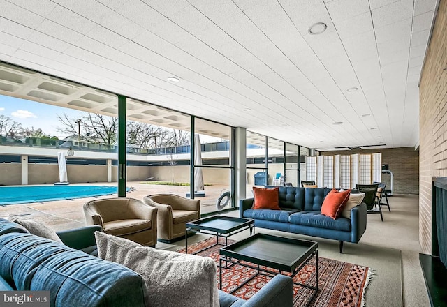 sunroom / solarium featuring a large fireplace