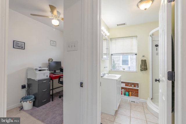 office area featuring light tile patterned flooring, sink, and ceiling fan