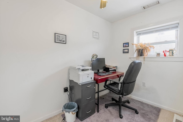 carpeted office featuring ceiling fan