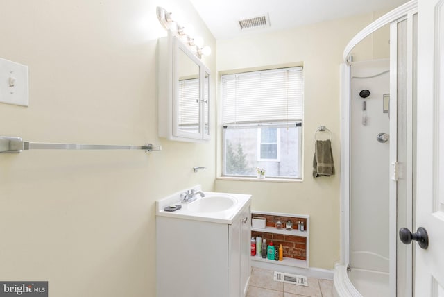 bathroom featuring vanity, an enclosed shower, and tile patterned floors