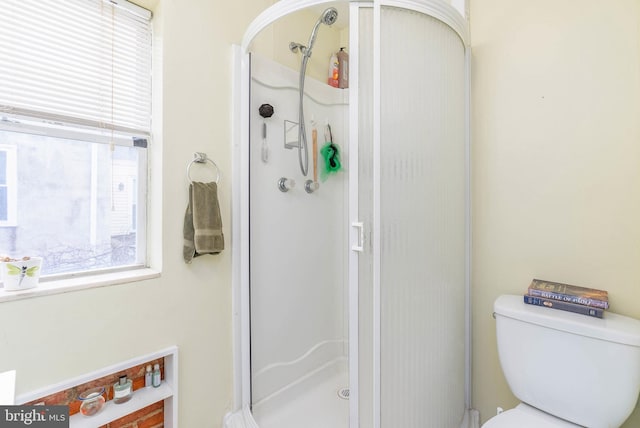 bathroom with toilet and walk in shower