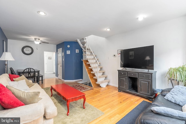 living room featuring ceiling fan and hardwood / wood-style floors