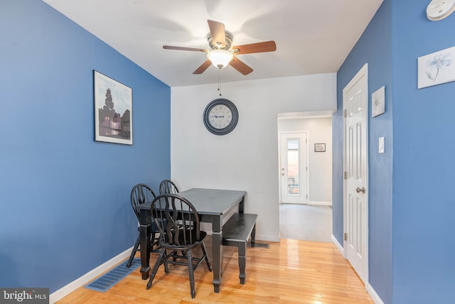 dining area with ceiling fan and hardwood / wood-style floors