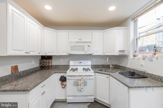 kitchen with white cabinetry, white appliances, and sink