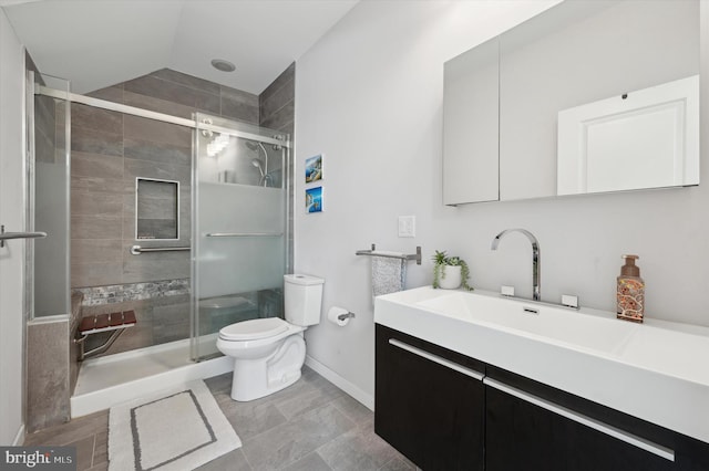 full bathroom with lofted ceiling, toilet, vanity, baseboards, and a stall shower