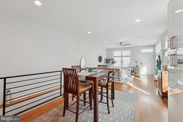 dining space with light wood-type flooring, ceiling fan, and recessed lighting