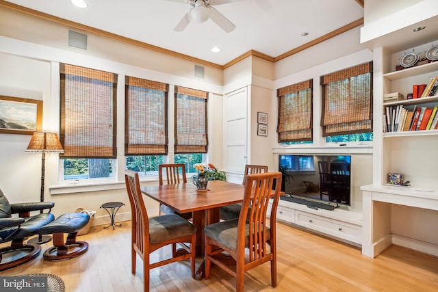 dining room with ornamental molding, ceiling fan, and light hardwood / wood-style floors