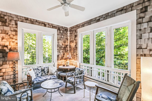 sunroom featuring ceiling fan