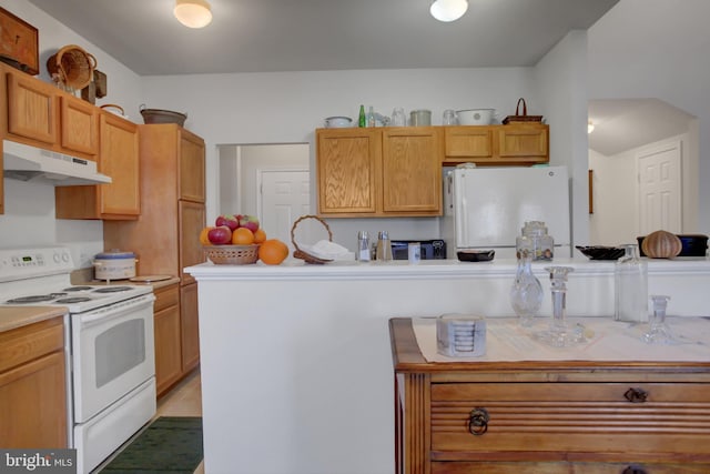 kitchen with white appliances, under cabinet range hood, and light countertops