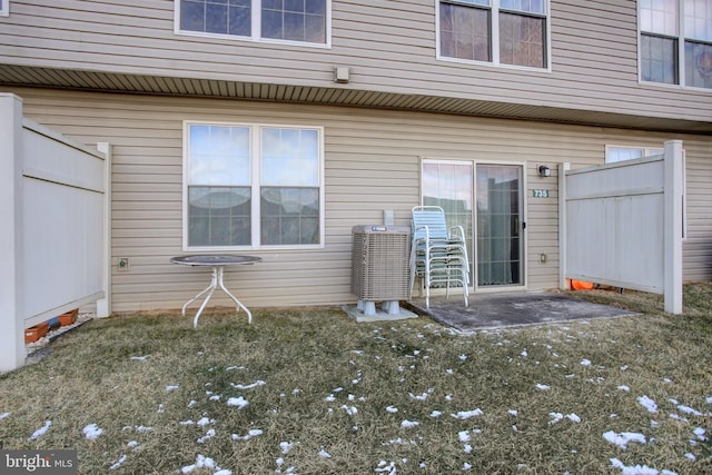 doorway to property with a yard, a patio area, and fence