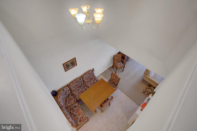 stairway featuring tile patterned floors and an inviting chandelier