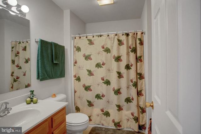 bathroom with toilet, curtained shower, and vanity