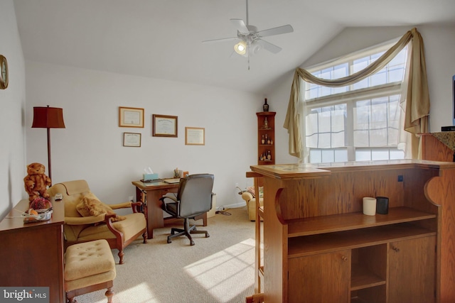 home office featuring ceiling fan, vaulted ceiling, and light colored carpet