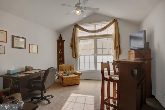 office area with ceiling fan, vaulted ceiling, and light colored carpet