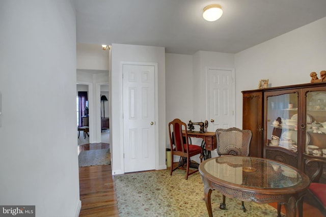 living area featuring baseboards and wood finished floors