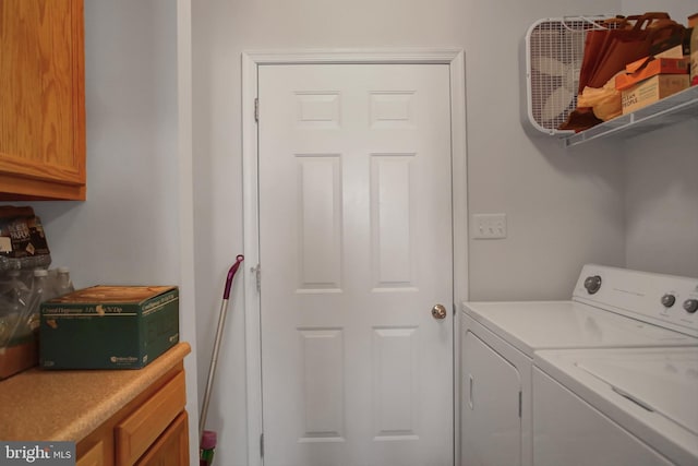 laundry area with cabinet space and independent washer and dryer