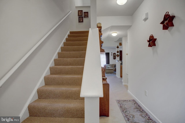 stairway featuring baseboards