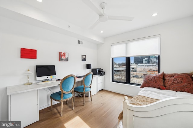 home office featuring ceiling fan and light hardwood / wood-style flooring