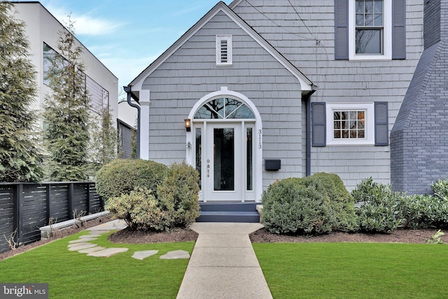 entrance to property with a lawn