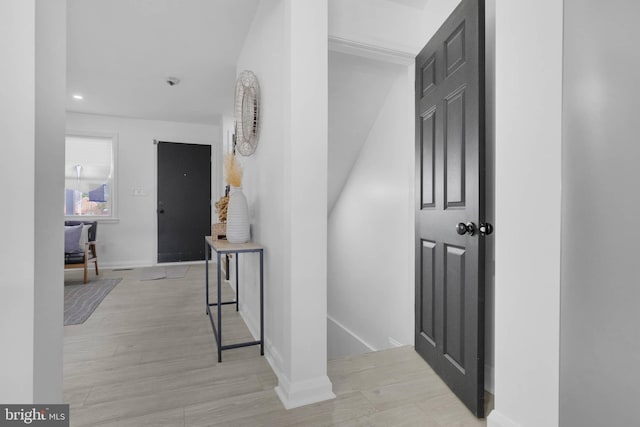 corridor with light wood-type flooring