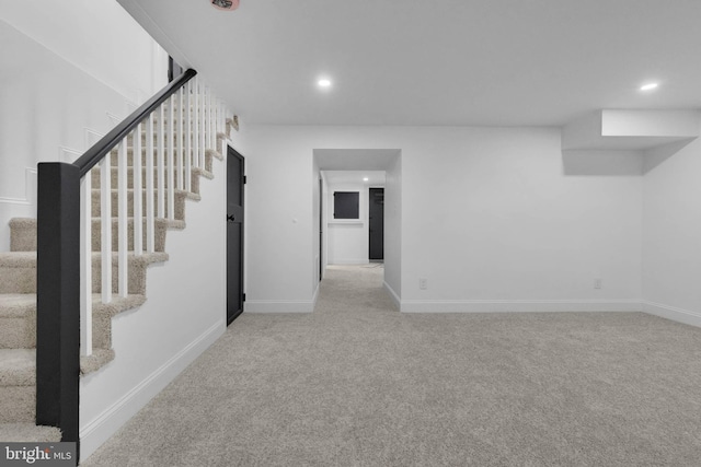 basement featuring light colored carpet