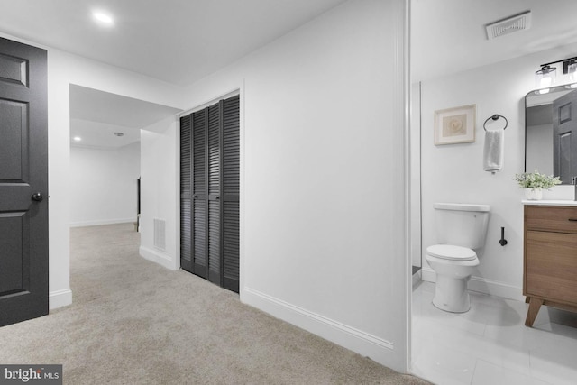 bathroom with toilet and vanity