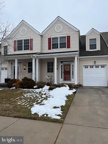 view of front of property with covered porch, driveway, and an attached garage