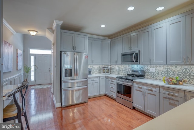 103 Candor Ln, Dover, DE 19901 - kitchen featuring stainless steel appliances, light countertops, backsplash, and light wood finished floors