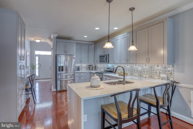 103 Candor Ln, Dover, DE 19901 - kitchen with tasteful backsplash, dark wood-style floors, appliances with stainless steel finishes, light countertops, and a sink