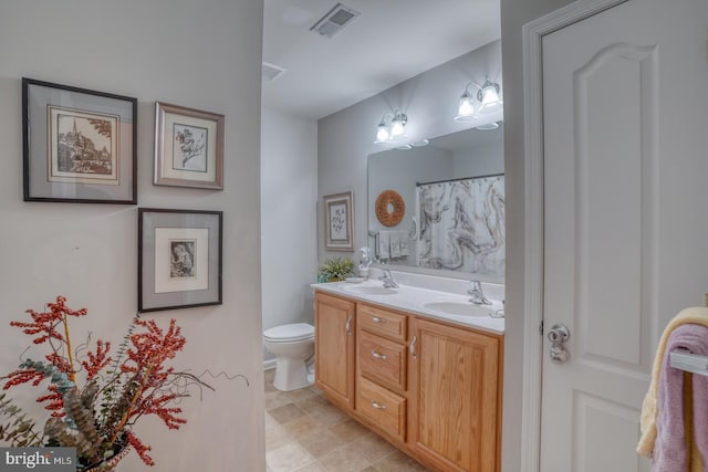 103 Candor Ln, Dover, DE 19901 - full bath featuring visible vents, a sink, toilet, and double vanity
