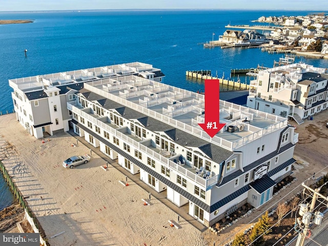 birds eye view of property with a water view