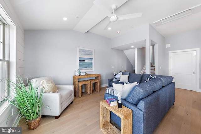 living room with lofted ceiling, light wood-type flooring, stairs, and recessed lighting