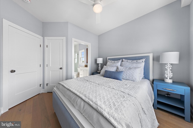 bedroom featuring ceiling fan, connected bathroom, and wood finished floors