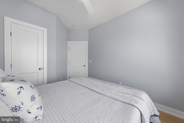 bedroom with ceiling fan, baseboards, and wood finished floors