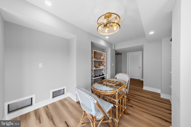 dining room with recessed lighting, visible vents, baseboards, and wood finished floors