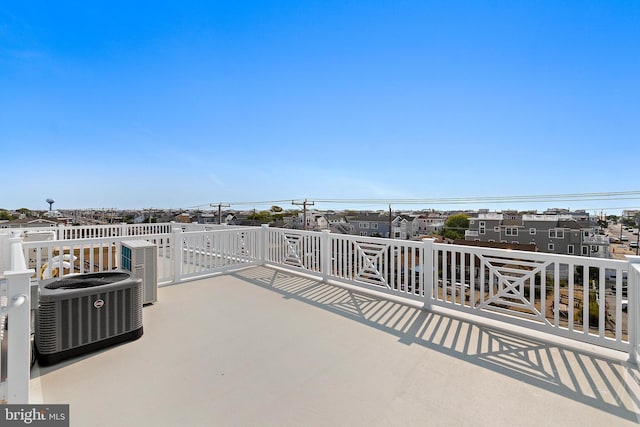 view of patio with a residential view and central air condition unit