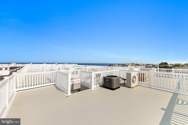 view of patio / terrace with a water view and central air condition unit