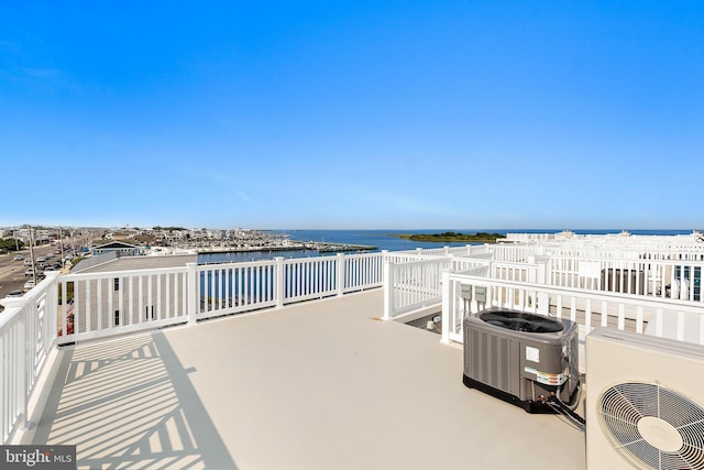 view of patio with a water view, ac unit, and central air condition unit