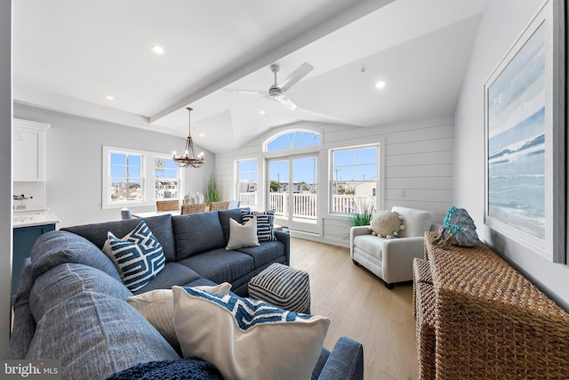 living room with light wood-type flooring, vaulted ceiling with beams, recessed lighting, and ceiling fan with notable chandelier